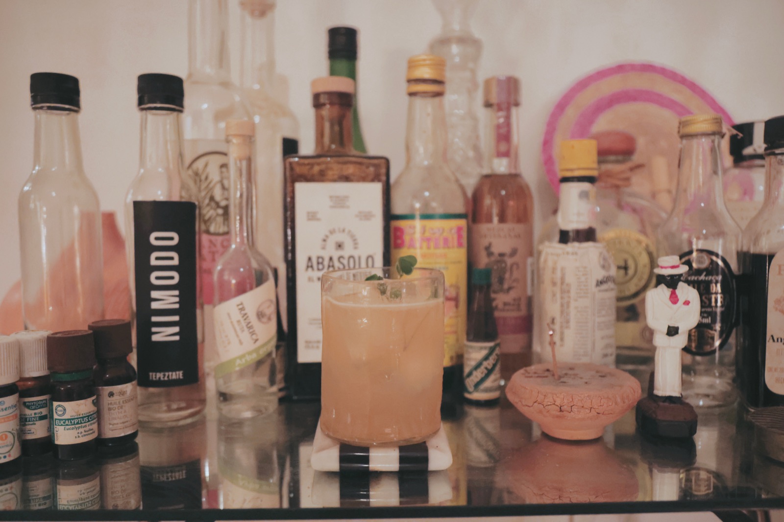 A real home bar with bottles and a cocktail